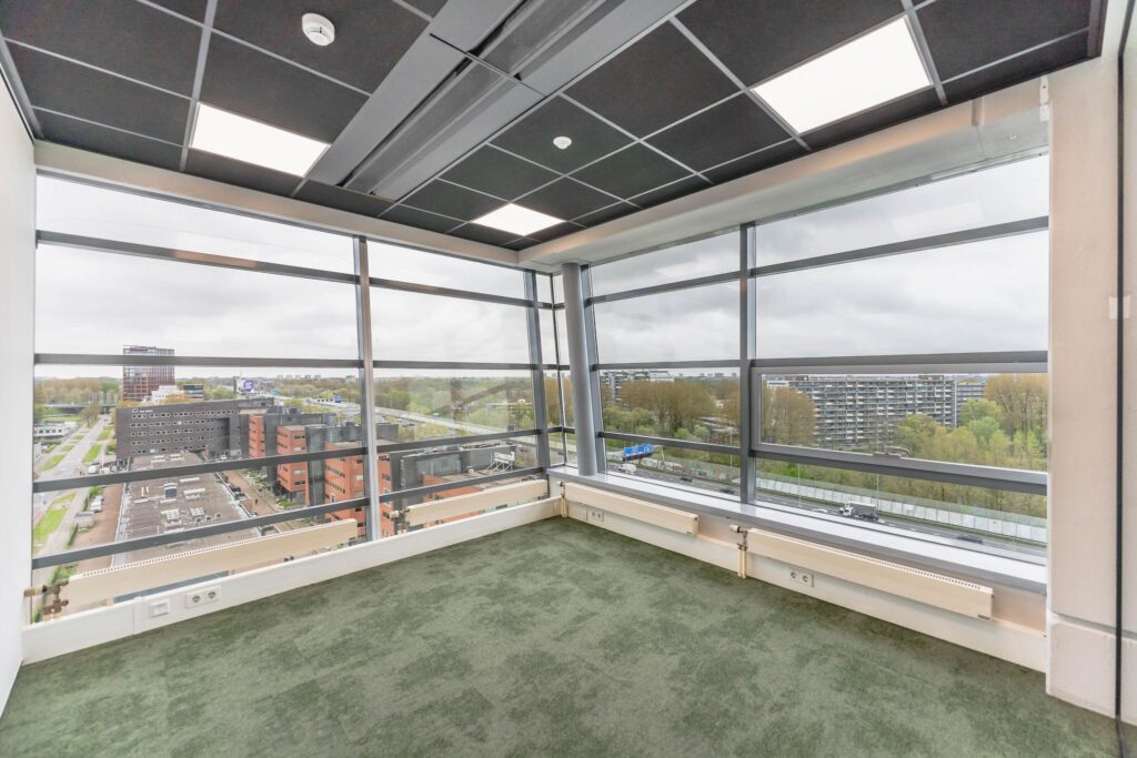 Corner office space with large windows and a panoramic view over Joop Geesinkweg in Amsterdam.